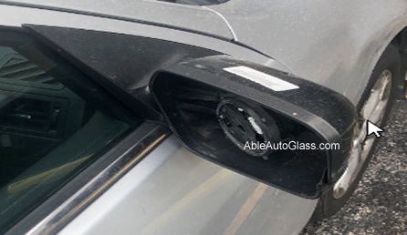 Someone nicked the back cover and glass mirror of the passenger door glass mirror.  
The client was new to Houston, TX from Michigan, and stayed at a hotel when somebody stole the mirror parts. The car is silver, and the mirror is black that had a silver backing.